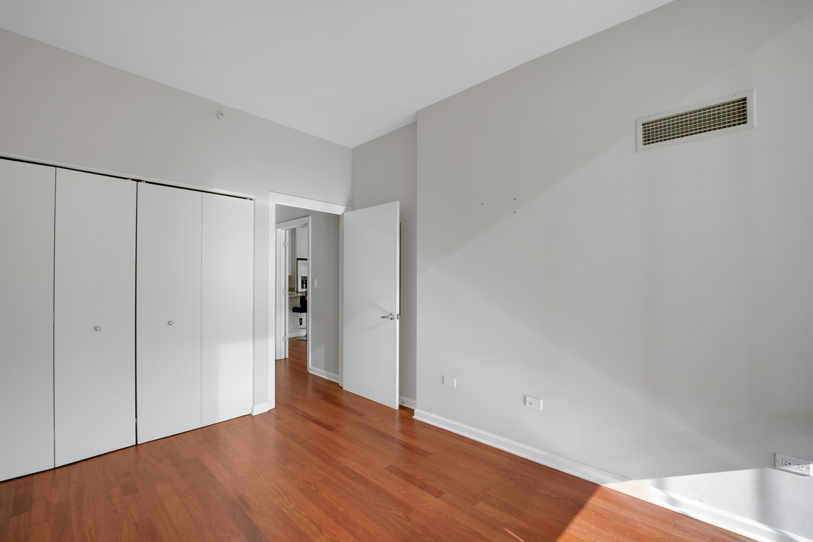1201 South Prairie Avenue, Unit 2404 Chicago, IL 60605 - Photo 11 of 25 a view of an empty room with wooden floor