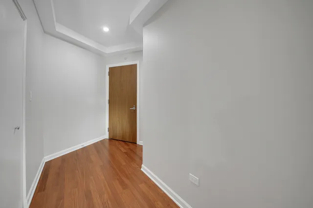 a view of a room with wooden floor