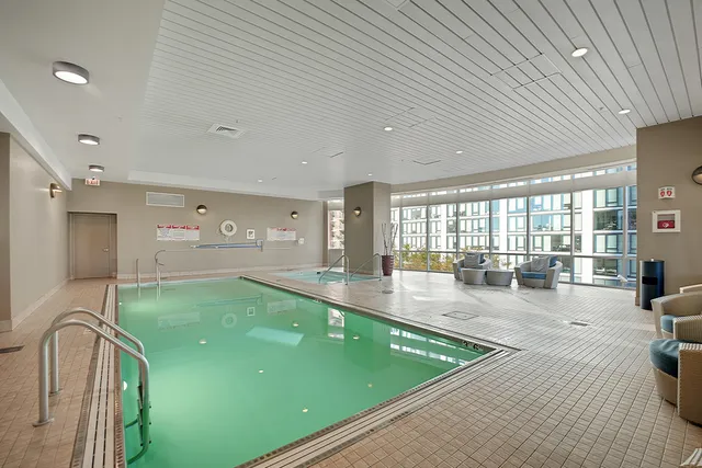 a large swimming pool with chairs