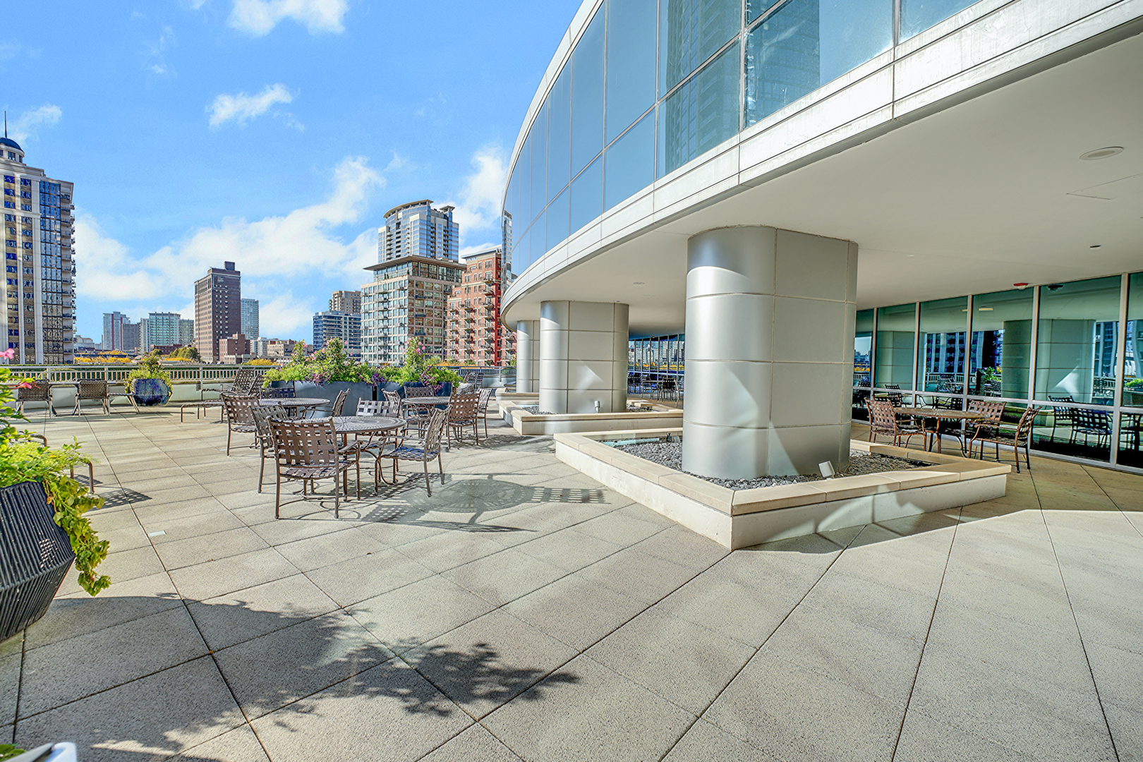 1201 South Prairie Avenue, Unit 2404 Chicago, IL 60605 - Photo 22 of 25 a view of a patio with dining table and chairs with potted plants