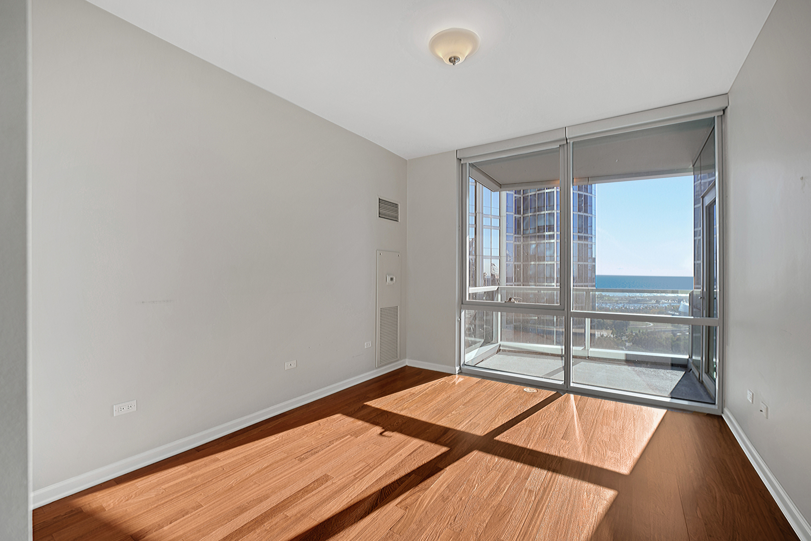 1201 South Prairie Avenue, Unit 2404 Chicago, IL 60605 - Photo 6 of 25 a room with a bed and glass door