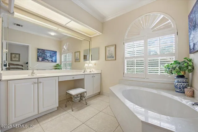 a spacious bathroom with a granite countertop sink mirror and bathtub