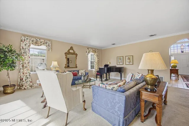 a living room with furniture a lamp and a potted plant