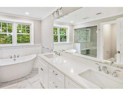 24 Wilson Road Lexington, MA 02421 - Photo 19 of 29 a bathroom with a double vanity sink large mirror and a bathtub