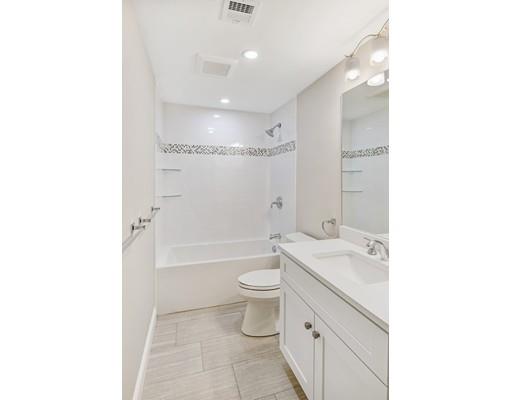 24 Wilson Road Lexington, MA 02421 - Photo 28 of 29 a bathroom with a granite countertop sink a toilet and shower
