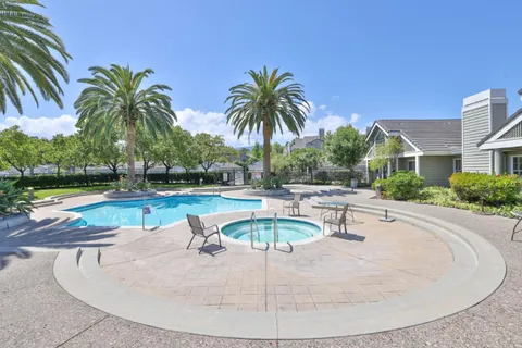 an outdoor space with swimming pool and furniture