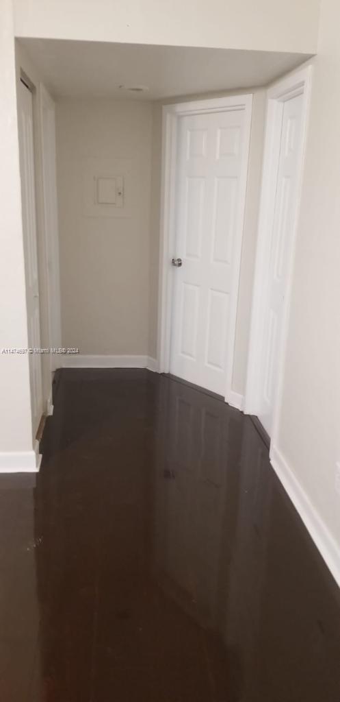 180 Northeast 71st Street, Unit 2 Miami, FL 33138 - Photo 5 of 10 a view of wooden floor and brick walls