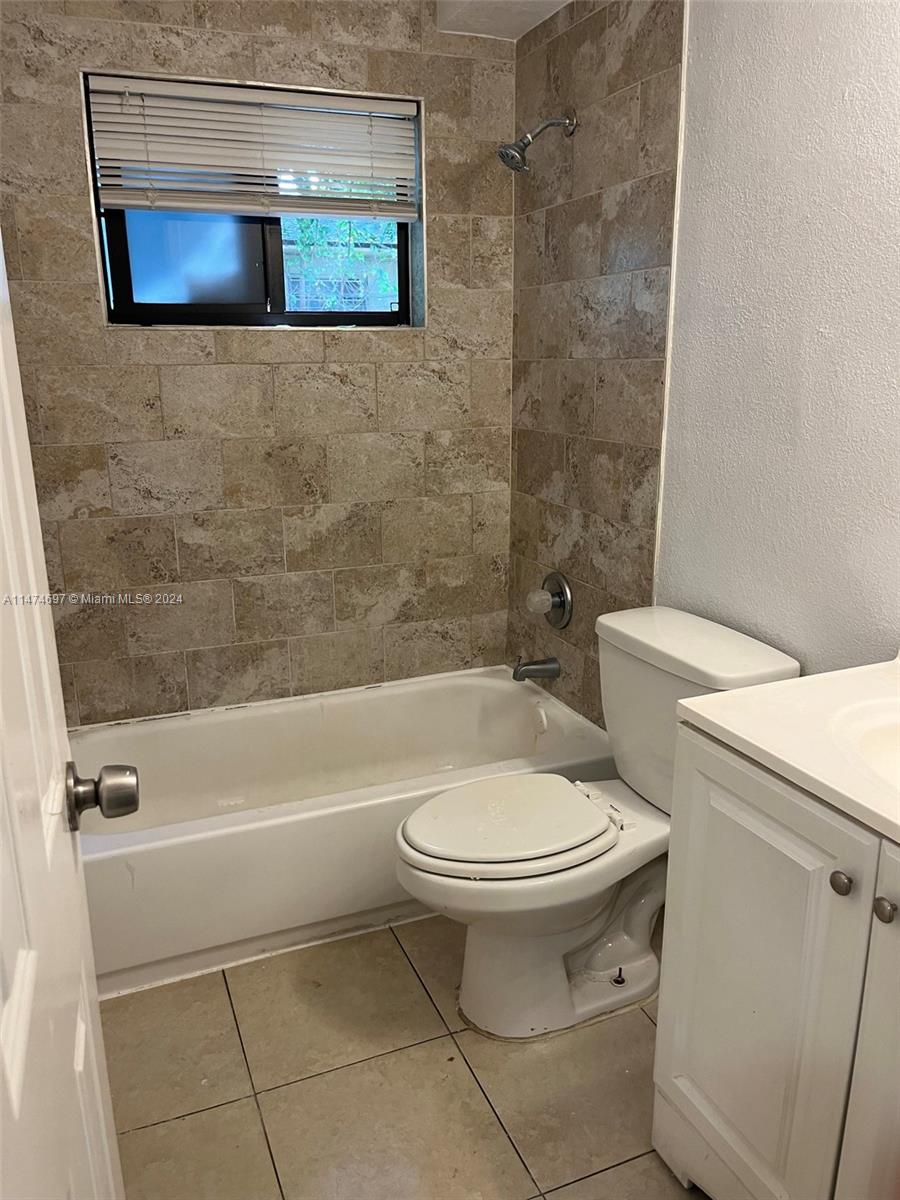 180 Northeast 71st Street, Unit 2 Miami, FL 33138 - Photo 8 of 10 a bathroom with a toilet and a bathtub