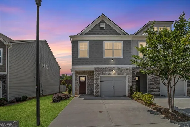 a front view of a house with a yard and garage