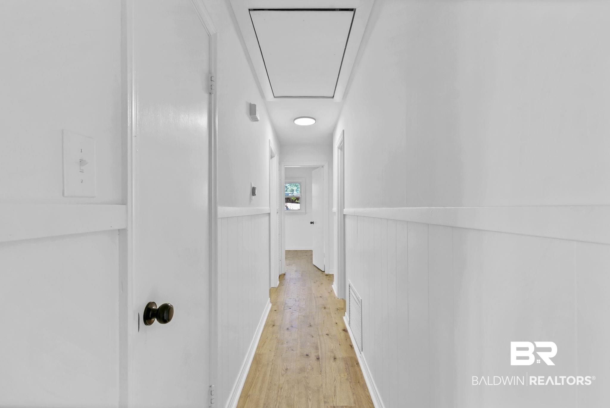 203 Anderson Road Saraland, AL 36571 - Photo 28 of 48 Corridor with light wood-style flooring, attic access, and wainscoting