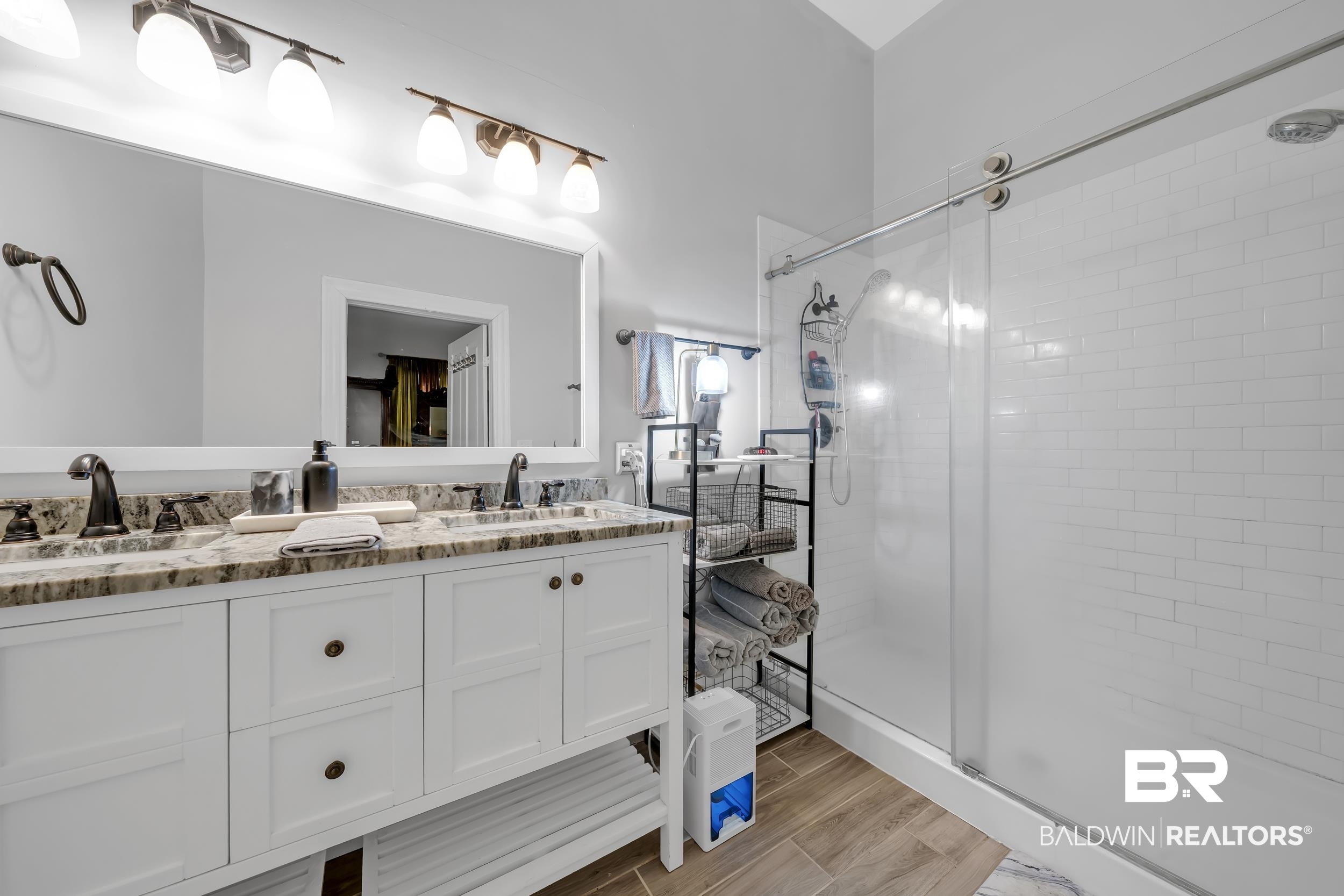 1322 Dauphin Street Mobile, AL 36604 - Photo 14 of 21 Bathroom featuring a stall shower, double vanity, and wood tiled floors