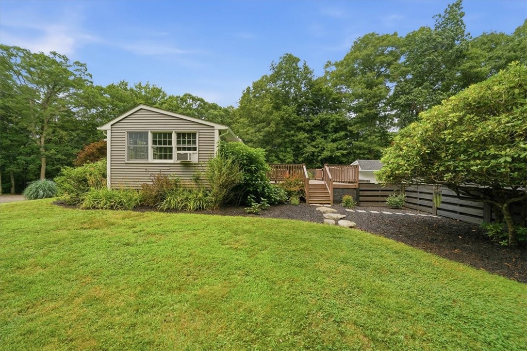214 Anan Wade Road Glocester, RI 02857 - Photo 49 of 50 Another view of the side yard looking towards the house and deck. Beautiful garden beds abound!