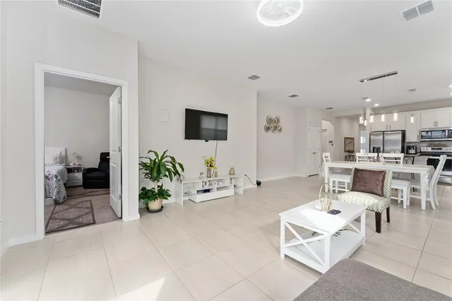 a living room with furniture a rug and white walls