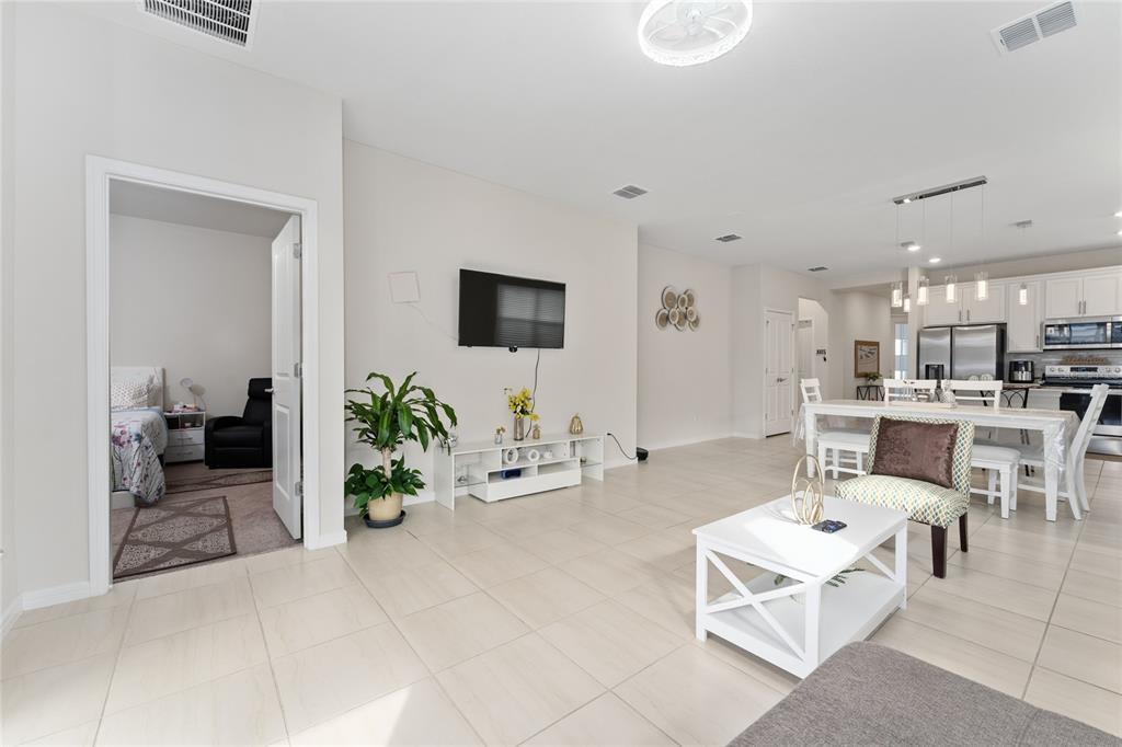 1880 Spring Shower Circle Kissimmee, FL 34744 - Photo 12 of 43 a living room with furniture a rug and white walls