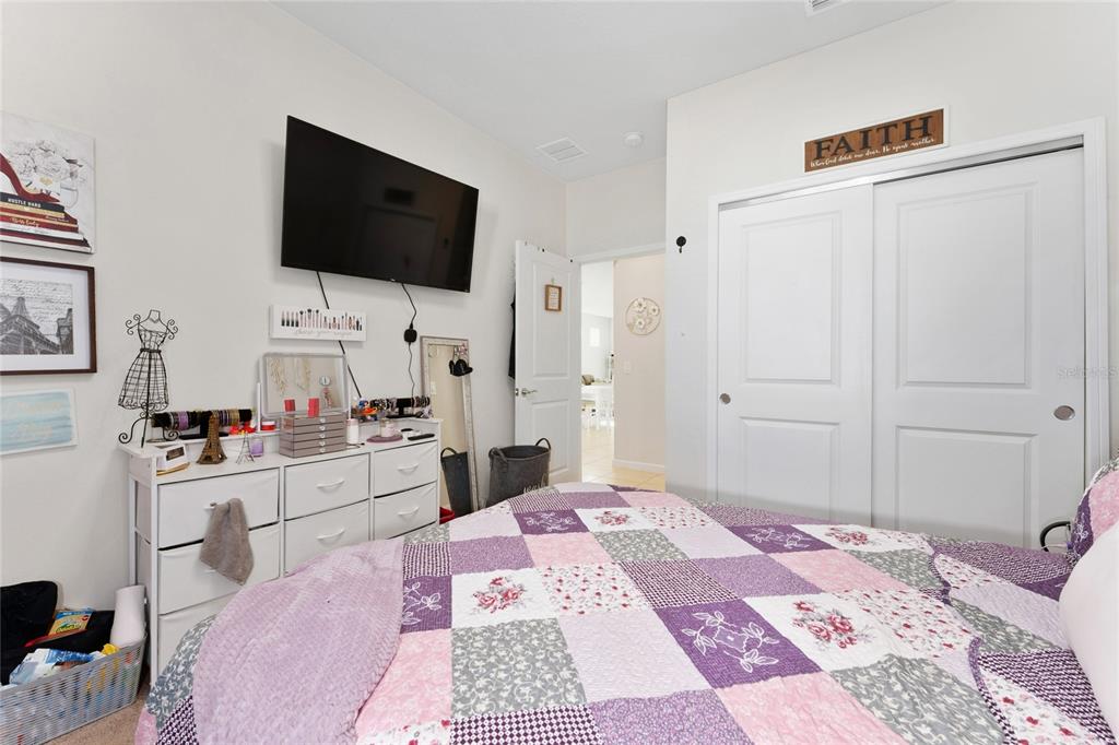 1880 Spring Shower Circle Kissimmee, FL 34744 - Photo 16 of 43 a bedroom with a bed and a flat screen tv