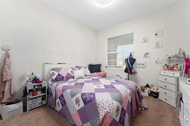 a bed room with a bed and a window