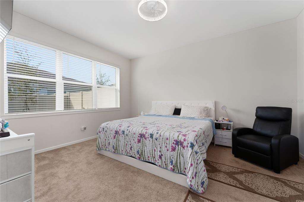 1880 Spring Shower Circle Kissimmee, FL 34744 - Photo 18 of 43 a bedroom with a bed chair and couch