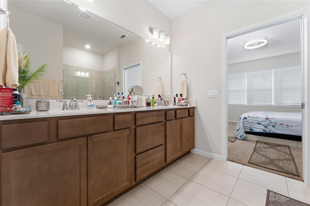 1880 Spring Shower Circle Kissimmee, FL 34744 - Photo 20 of 43 a bathroom with a sink a vanity and a mirror