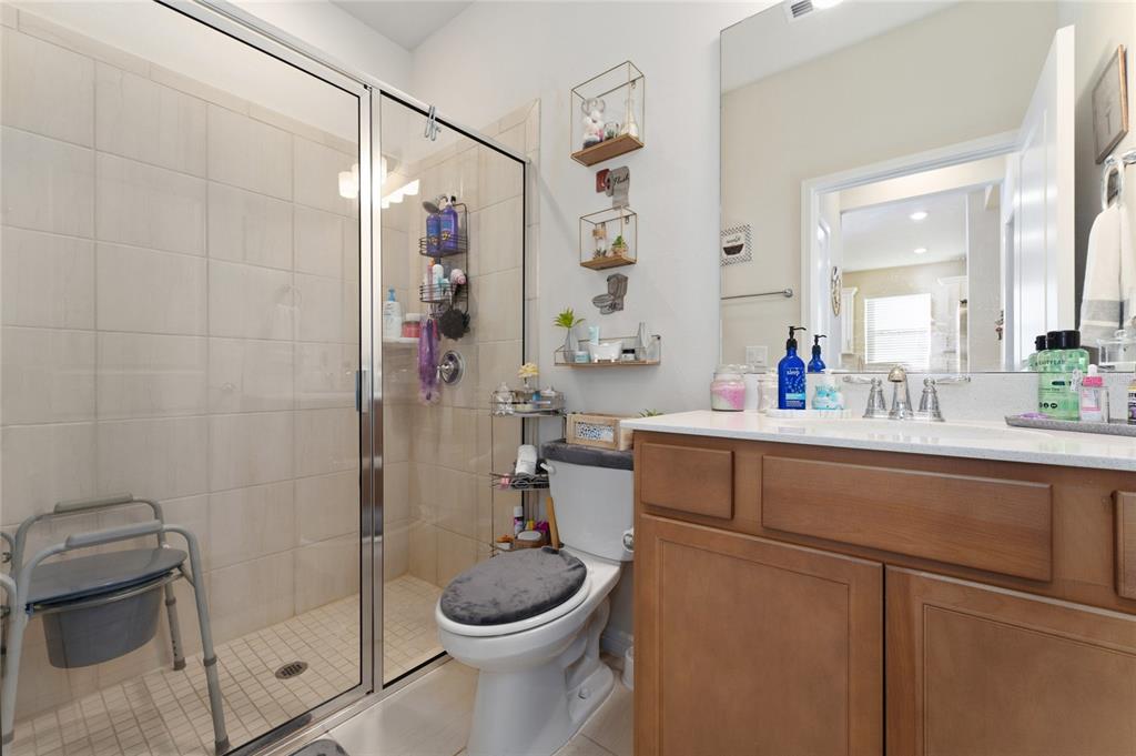 1880 Spring Shower Circle Kissimmee, FL 34744 - Photo 22 of 43 a bathroom with a sink a toilet and shower