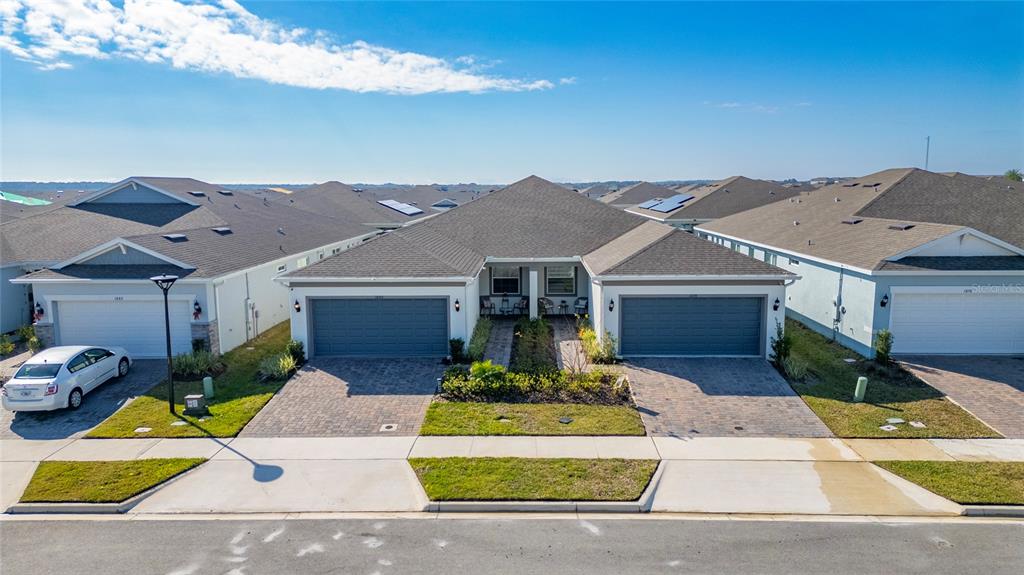 1880 Spring Shower Circle Kissimmee, FL 34744 - Photo 3 of 43 a front view of a house with a yard and garage