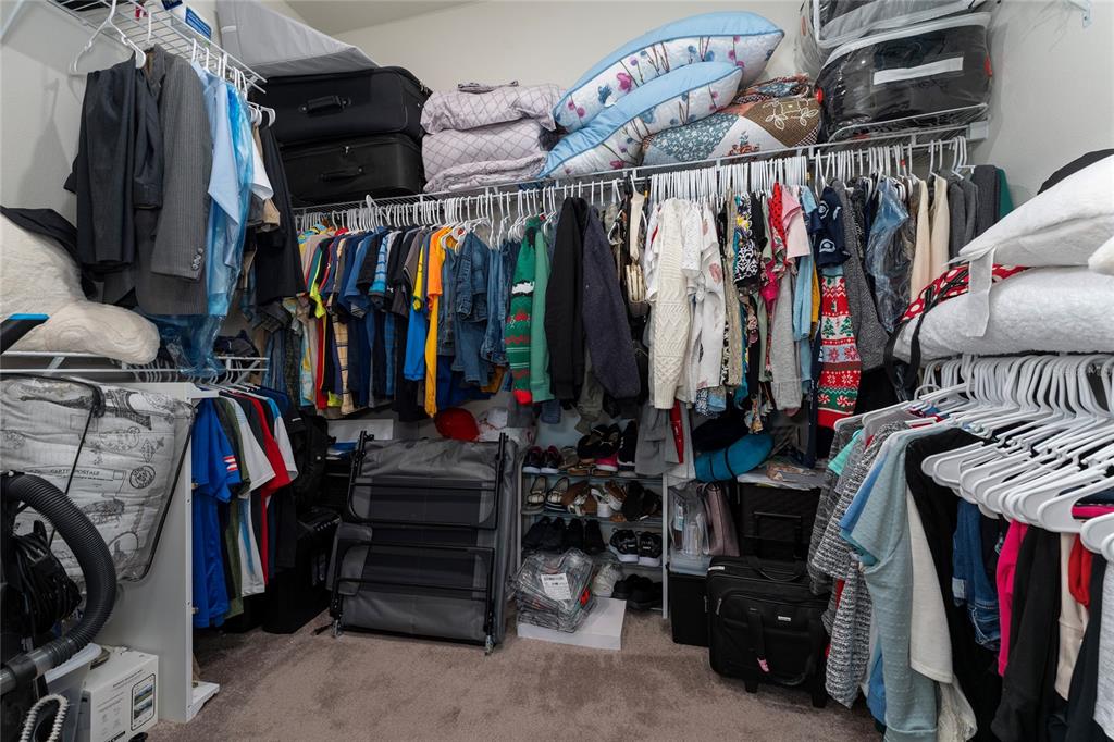 1880 Spring Shower Circle Kissimmee, FL 34744 - Photo 31 of 43 a view of walk in closet with clothes and shoes