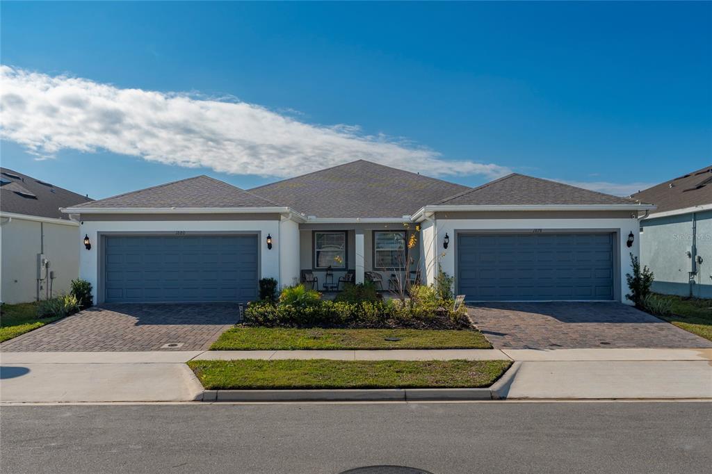 1880 Spring Shower Circle Kissimmee, FL 34744 - Photo 4 of 43 a front view of a house with a garden