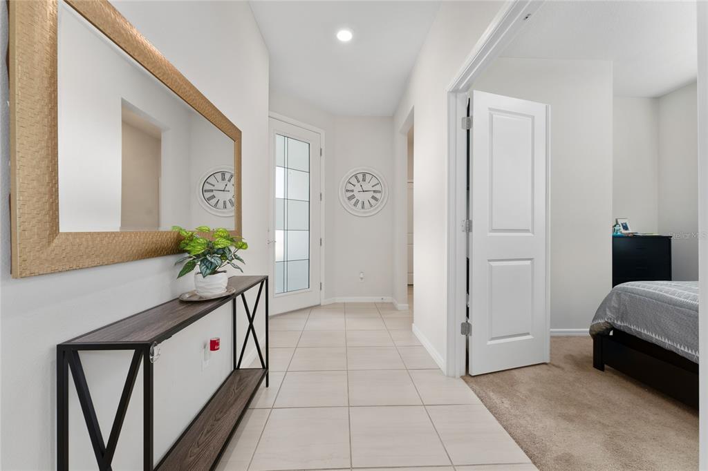 1880 Spring Shower Circle Kissimmee, FL 34744 - Photo 7 of 43 a spacious bedroom with a bed and a potted plant