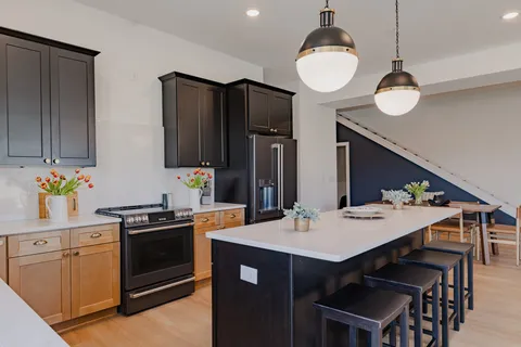 a kitchen with a sink stove and cabinets