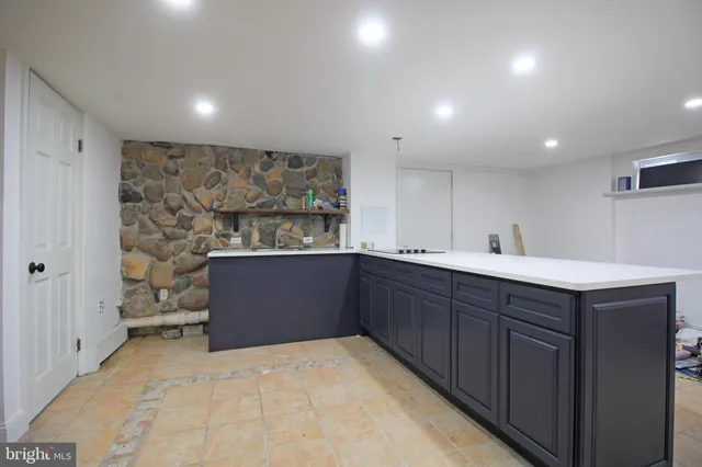 a room with a table chairs and a painting on the wall