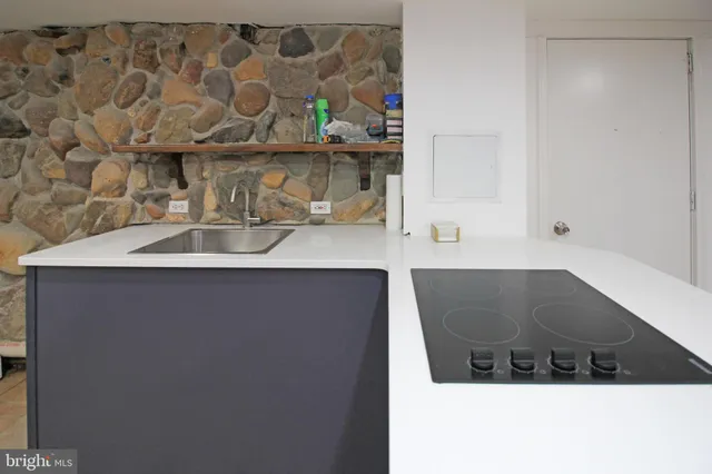 a view of a livingroom with wooden floor and a staircase