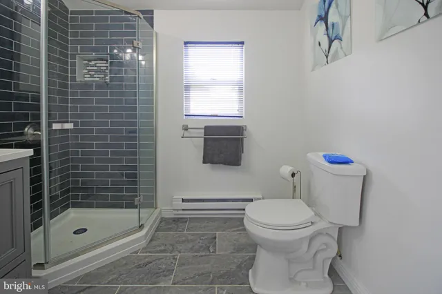 a dining room with wooden floor and a chandelier
