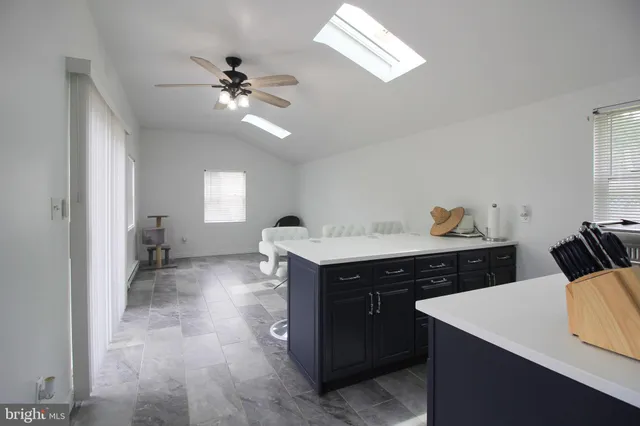 a view of kitchen island with sink wooden floor and chair