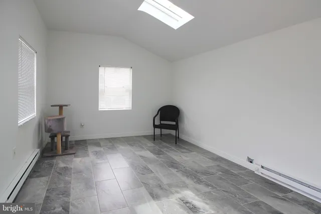 a view of a house with a yard and sitting area