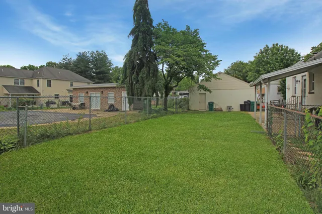 a view of backyard with outdoor seating and plants