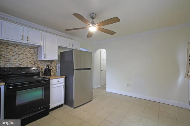 a kitchen with cabinets stainless steel appliances and a counter space