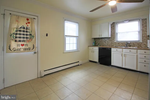 a view of a kitchen with cabinets appliances and a window