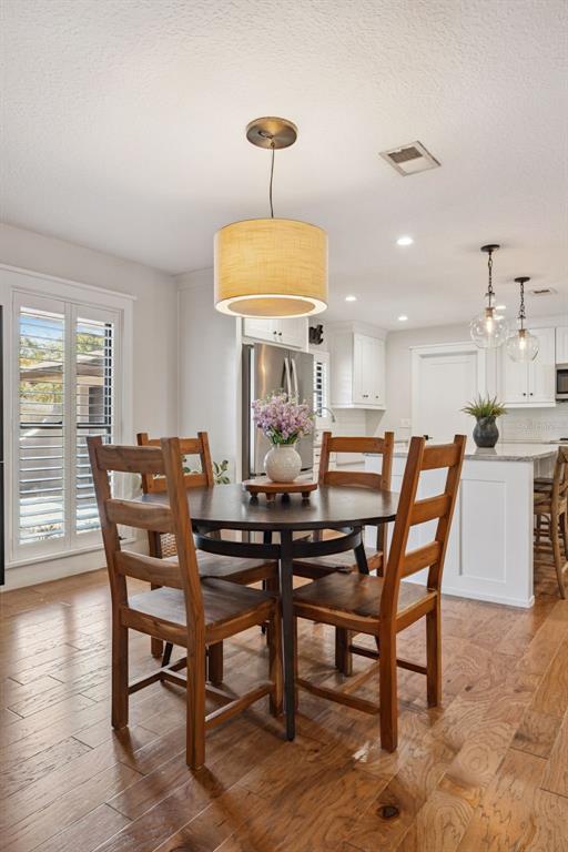 2609 Summerfield Road Winter Park, FL 32792 - Photo 12 of 40 a view of a dining room with furniture and wooden floor