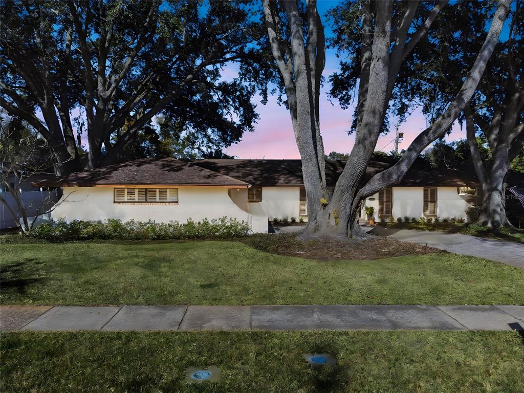 2609 Summerfield Road Winter Park, FL 32792 - Photo 2 of 40 a view of a white house next to a yard with big trees