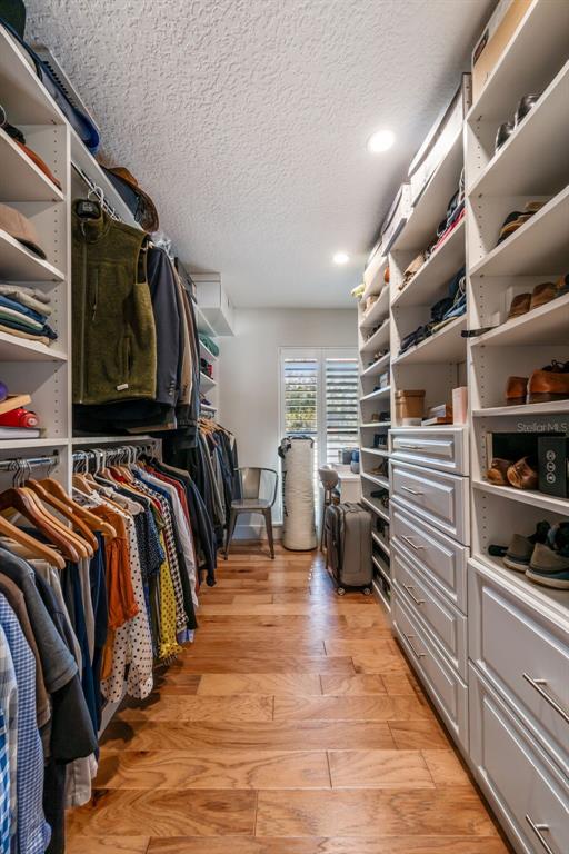 2609 Summerfield Road Winter Park, FL 32792 - Photo 23 of 40 a view of walk in closet with clothes and shoes