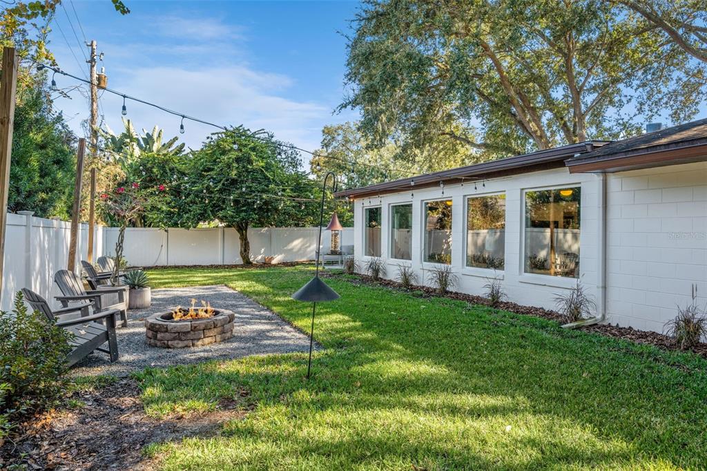 2609 Summerfield Road Winter Park, FL 32792 - Photo 38 of 40 a view of a backyard with table and chairs potted plants and large tree