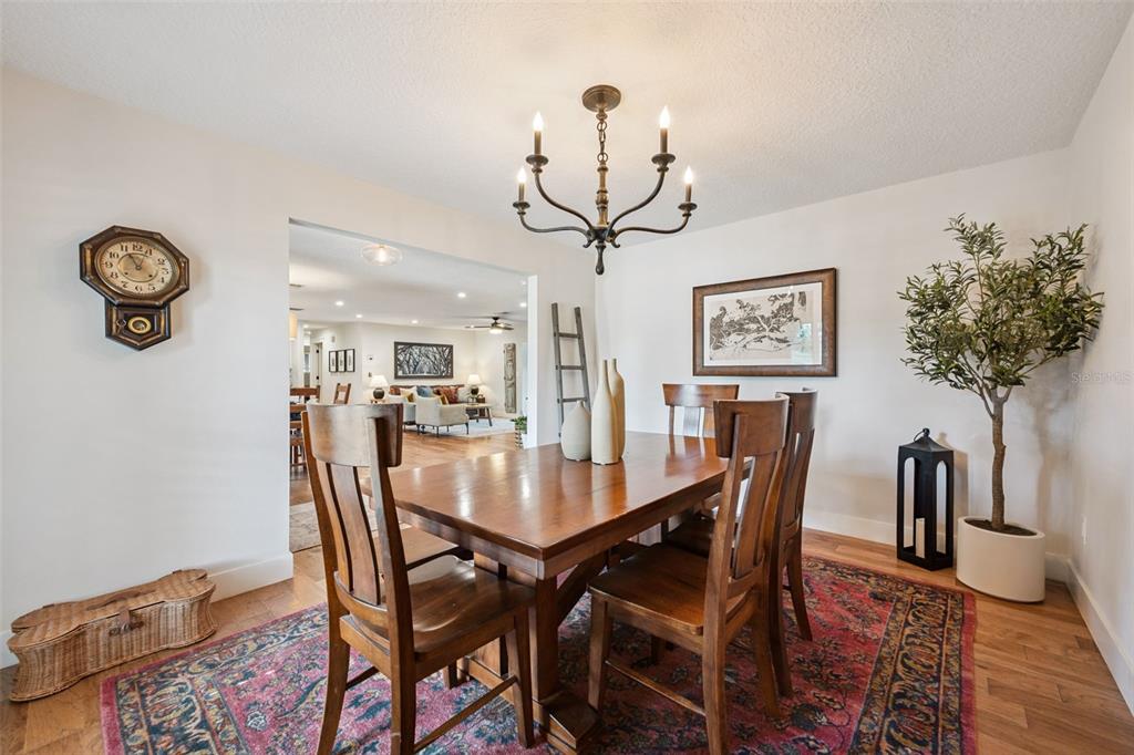 2609 Summerfield Road Winter Park, FL 32792 - Photo 7 of 40 a view of a dining room and livingroom with furniture a rug and a chandelier