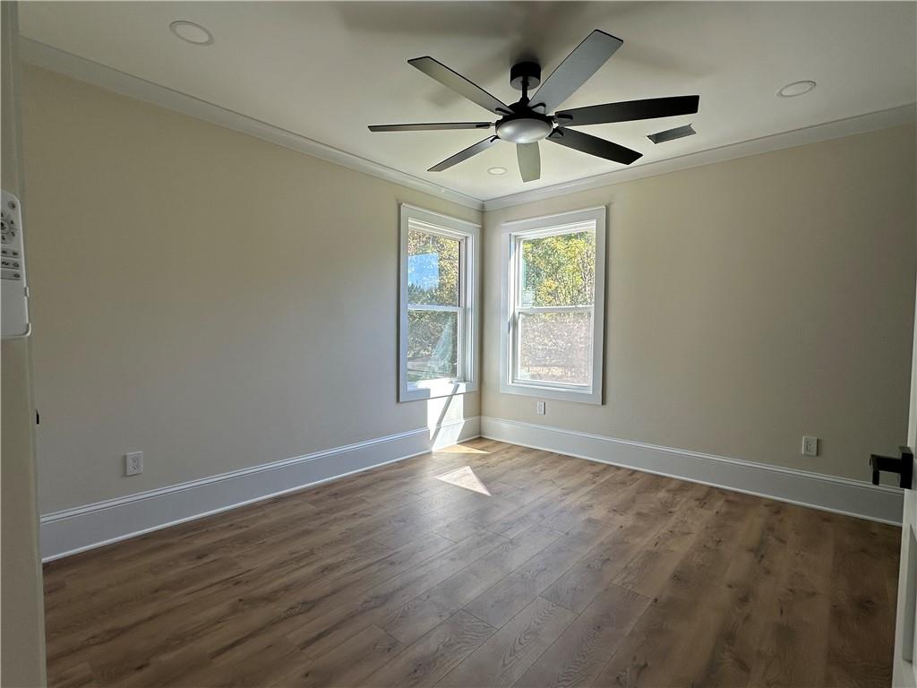 3354 Plainview Road Maysville, GA 30558 - Photo 14 of 50 a view of an empty room with wooden floor and a window