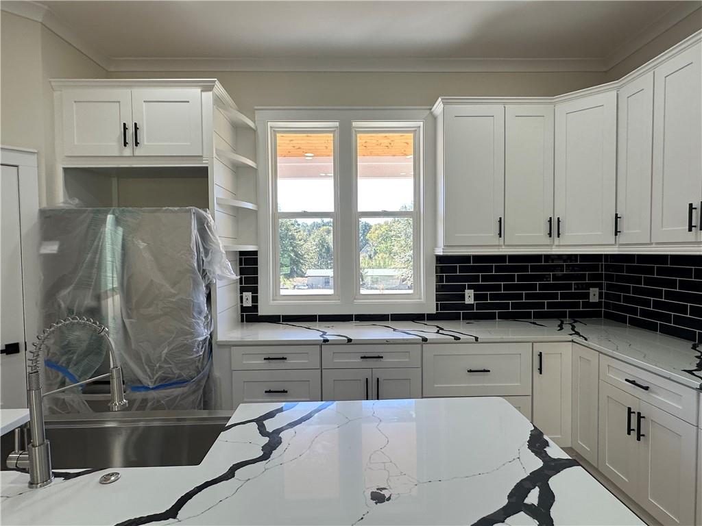 3354 Plainview Road Maysville, GA 30558 - Photo 4 of 50 a kitchen with a sink and white cabinets