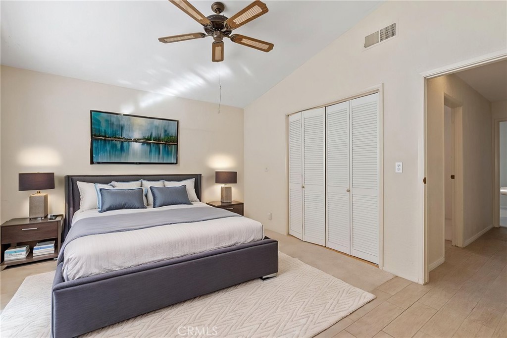 5385 Strasbourg Avenue Irvine, CA 92604 - Photo 38 of 59 a bedroom with a large bed a chandelier and closet