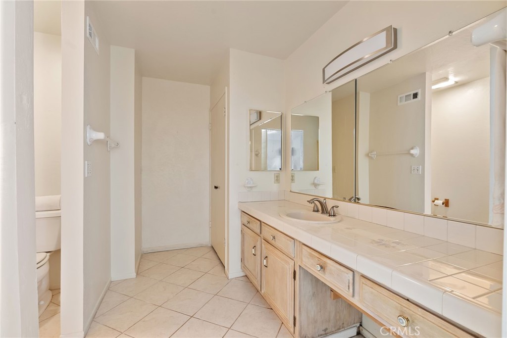 5385 Strasbourg Avenue Irvine, CA 92604 - Photo 39 of 59 a spacious bathroom with a granite countertop double vanity sink mirror and