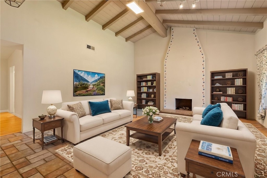 5385 Strasbourg Avenue Irvine, CA 92604 - Photo 8 of 59 a living room with furniture a rug and a bookshelf