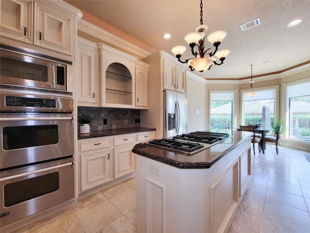 a kitchen with a stove oven and sink