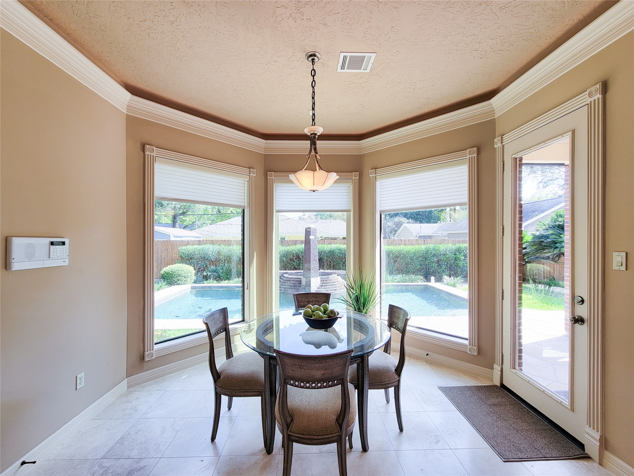 1118 Colonial Street Bellaire, TX 77401 - Photo 12 of 50 Bright dining area with large windows offering a view of the backyard pool. Natural light fills the space, creating a warm and inviting atmosphere.