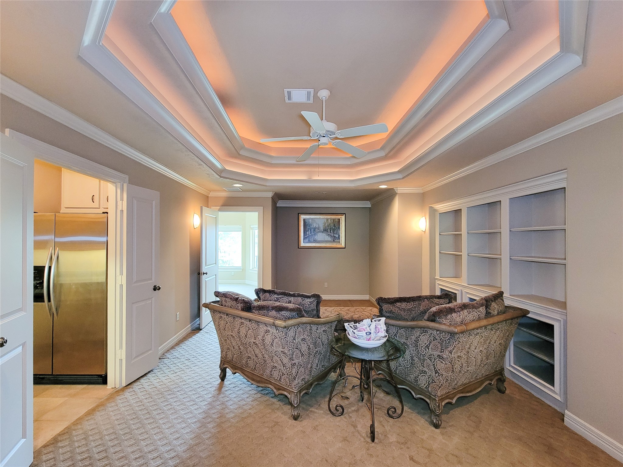 1118 Colonial Street Bellaire, TX 77401 - Photo 32 of 50 This elegant media room features a tray ceiling with ambient lighting with remote control rope lighting, ceiling fan and built-in shelving.