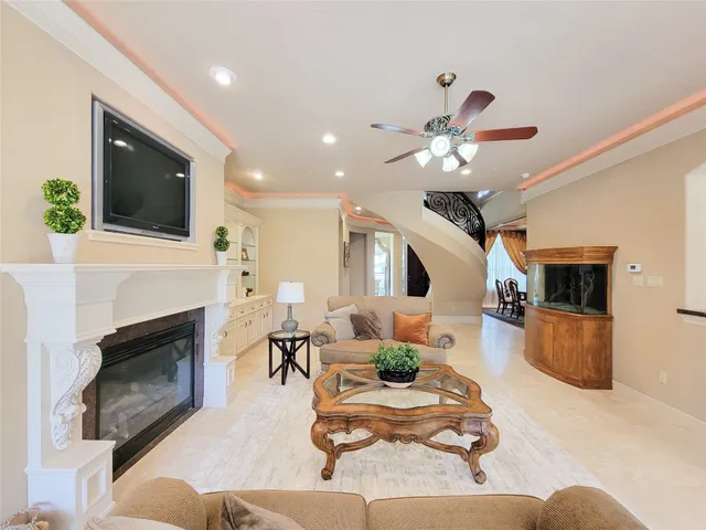 a living room with furniture fireplace and flat screen tv